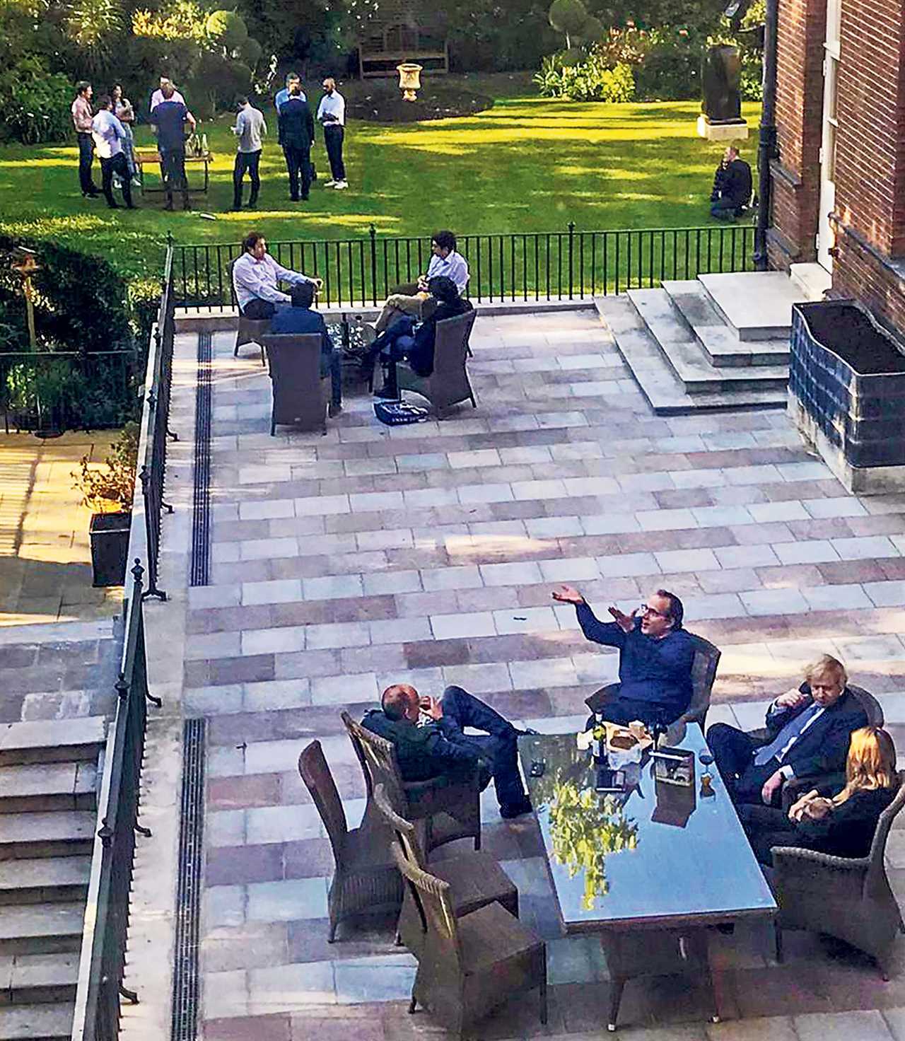 A picture of another gathering in the Downing St garden Credit: Guardian