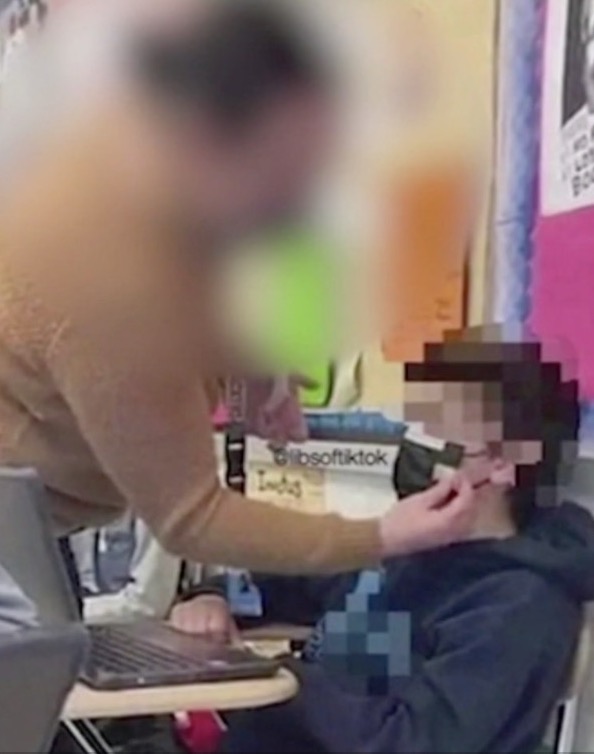 Fury as shock photo shows teacher taping mask to young student’s face