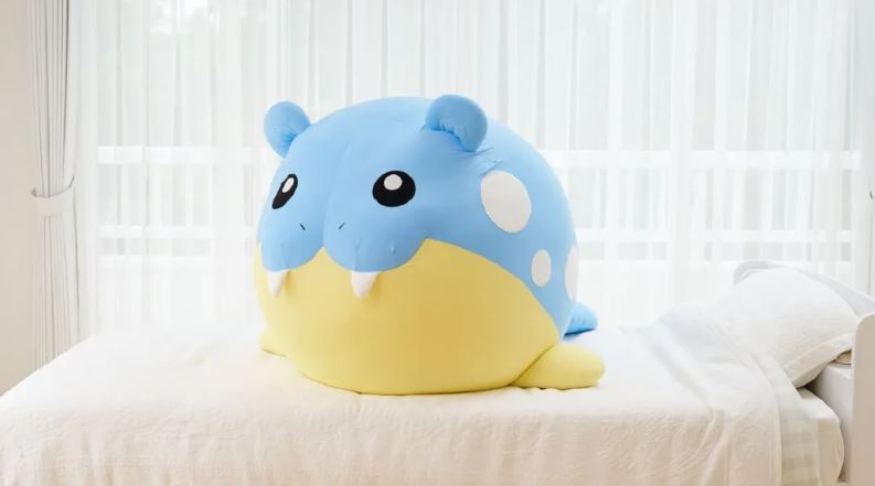 Life-size Spheal plush size on a bed