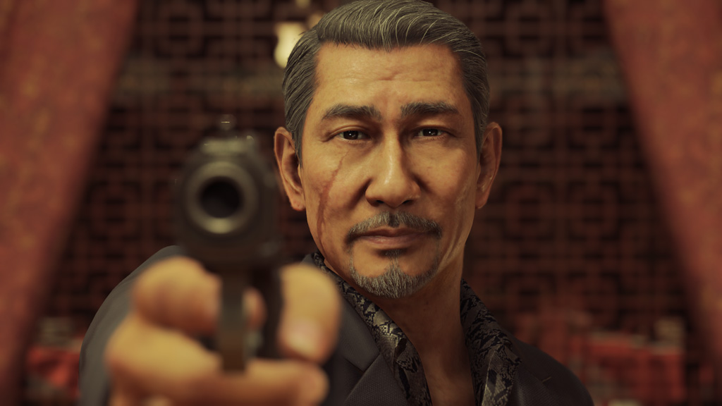 A man points a gun at the camera Yakuza: Like a Dragon