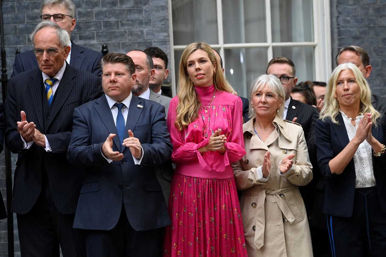 Doting Carrie Johnson holds hands with Boris as he makes final speech outside Downing Street