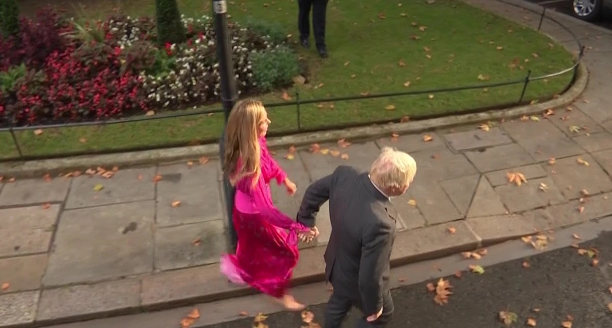 Doting Carrie Johnson holds hands with Boris as he makes final speech outside Downing Street