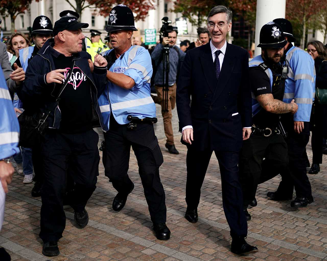 Tory MPs escorted by police while chased and pelted by leftie mob outside party conference in Birmingham