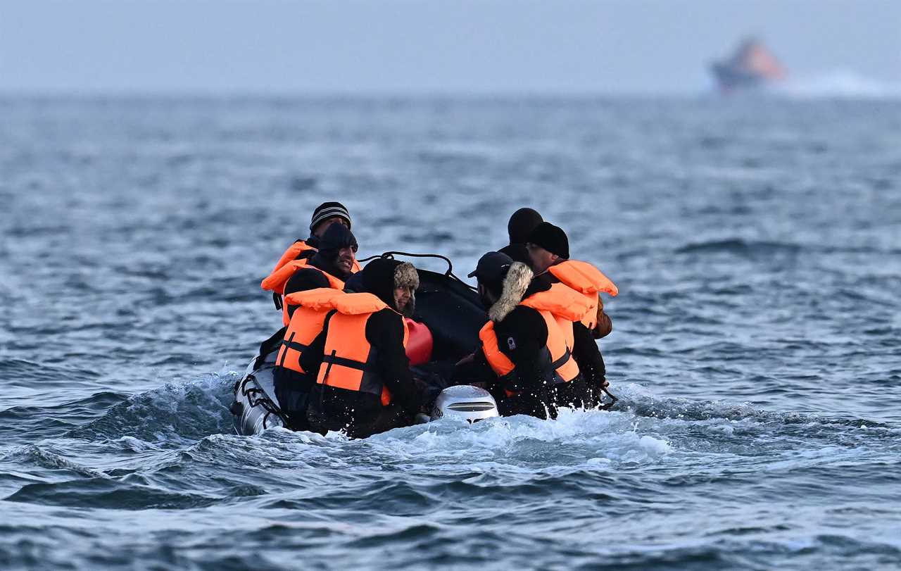 Royal National Lifeboat Institution (RNLI) Severn class lifeboat, the City of London II, makes its way towards migrants travelling in an inflatable boat across the English Channel, bound for Dover on the south coast of England. - More than 45,000 migrants arrived in the UK last year by crossing the English Channel on small boats. (Photo by Ben Stansall / AFP) (Photo by BEN STANSALL/AFP via Getty Images)