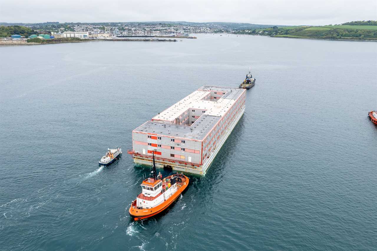 Huge three-storey barge that will house 500 migrants with a pool table and gym arrives in the UK