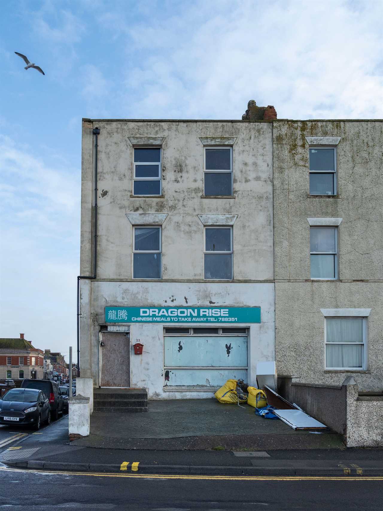 2HF6KHP Run down building with derelict Chinese Take Away shop at ground level, Esplanade, Burnham-on-Sea, Somerset, England