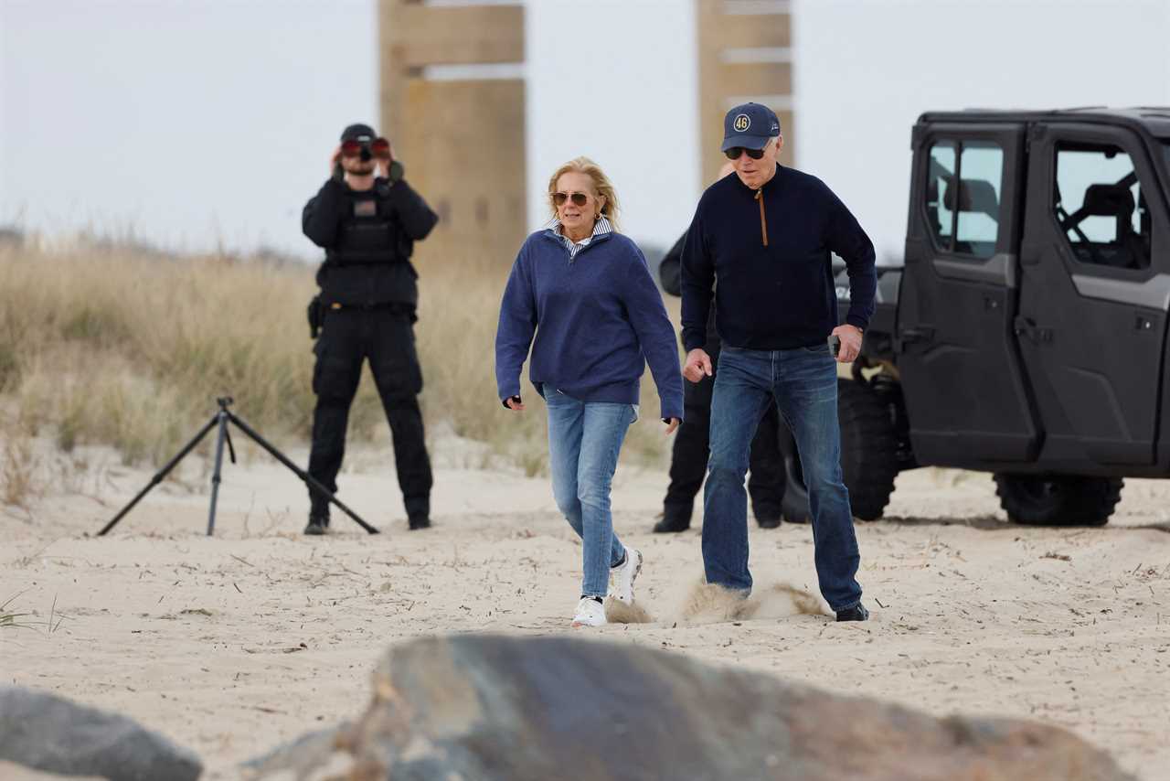 Joe Biden stumbles on sandy beach during day out in Delaware