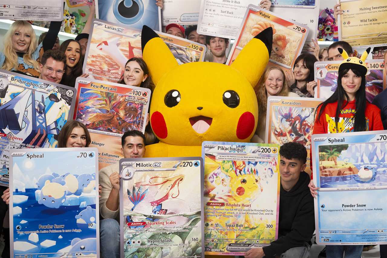 Pokémon fans and content creators pose with giant Pokémon cards they unboxed during the stream. Pictured left to right: Yekais, ZeroOfTime, Georgina Palanques, Niamh Fitzsimmons, Pinku_Kiwi, Victoria Clay, Charlotte Judge, Ross Gilbert, Eleonora, Toro96, Tom Burns, Abbey Simpson-Hughes, May Naidoo, Richard Page, Mia Crutchley, Rachel Gunn, Nicola Jennings, Joe Merrick